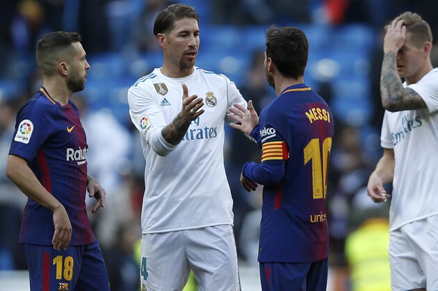 Real Madrid's Sergio Ramos, center left, shakes hands with Barcelona's Lionel Messi at the end of the Spanish La Liga soccer match between Real Madrid and Barcelona at the Santiago Bernabeu stadium in Madrid, Spain, Saturday, Dec. 23, 2017. Barcelona won 3-0. (AP Photo/Francisco Seco)
