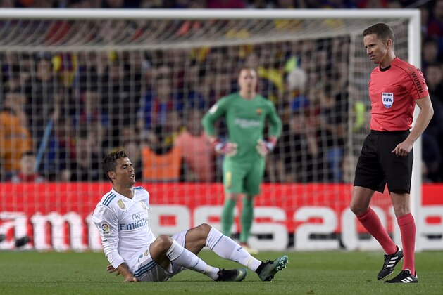 BARCELONA, SPAIN - MAY 06:  Cristiano Ronaldo of Real Madrid (R) is injured as he scores his sides first goal  during the La Liga match between Barcelona and Real Madrid at Camp Nou on May 6, 2018 in Barcelona, Spain.  (Photo by Alex Caparros/Getty Images)