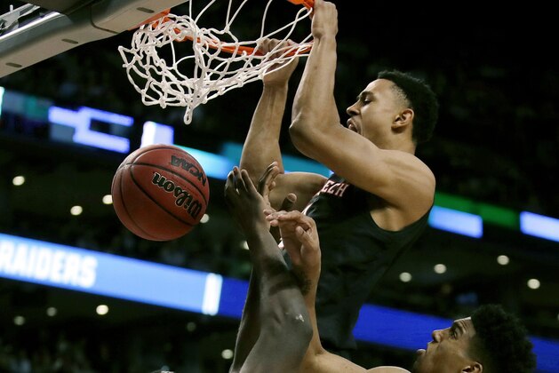 Texas Tech's Zhaire Smith, top, dunks over Villanova's Eric Paschall, center, during the second half of an NCAA men's college basketball tournament regional final, Sunday, March 25, 2018, in Boston. (AP Photo/Charles Krupa)
