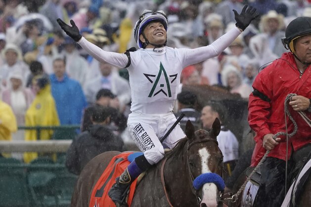 Mike Smith celebrates after riding Justify to victory during the 144th running of the Kentucky Derby horse race at Churchill Downs Saturday, May 5, 2018, in Louisville, Ky. (AP Photo/Morry Gash)