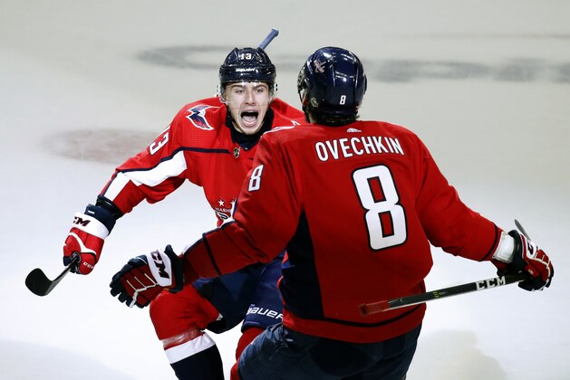 Washington Capitals left wing Jakub Vrana (13), from the Czech Republic, jumps into the arms of left wing Alex Ovechkin (8), from Russia, after Vrana scored the go-ahead goal during the third period of Game 5 in the second round of the NHL Stanley Cup hockey playoffs against the Pittsburgh Penguins, Saturday, May 5, 2018, in Washington. The Capitals won 6-3. (AP Photo/Alex Brandon)