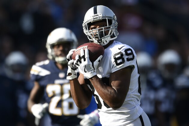 Oakland Raiders wide receiver Amari Cooper hauls in a pass on his way to scoring a touchdown during the first half of an NFL football game against the Los Angeles Chargers, Sunday, Dec. 31, 2017, in Carson, Calif. (AP Photo/Kelvin Kuo)
