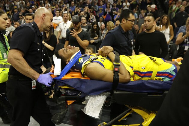 Golden State Warriors guard Patrick McCaw is taken off the court on a stretcher after falling hard to the floor late in the third quarter following a Flagrant 1 foul by Sacramento Kings's Vince Carter in an NBA basketball game Saturday, March 31, 2018, in Sacramento, Calif. The Warriors won 112-96. (AP Photo/Rich Pedroncelli)