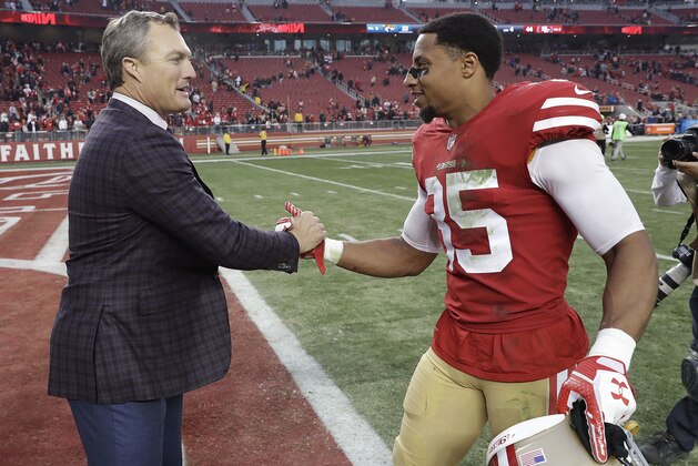 San Francisco 49ers general manager John Lynch, left, greets safety Eric Reid (35) after the 49ers beat the Jacksonville Jaguars in an NFL football game in Santa Clara, Calif., Sunday, Dec. 24, 2017. (AP Photo/Marcio Jose Sanchez)