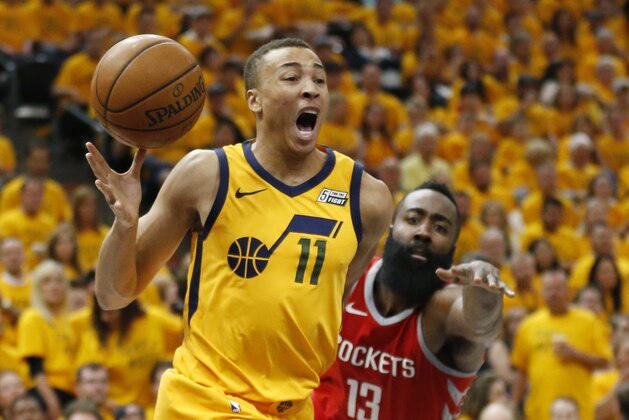 Utah Jazz guard Dante Exum (11) reacts after being injured as he drives around Houston Rockets guard James Harden (13) during the second half in Game 4 of an NBA basketball second-round playoff series Sunday, May 6, 2018, in Salt Lake City. The Rockets won 100-87. (AP Photo/Rick Bowmer)