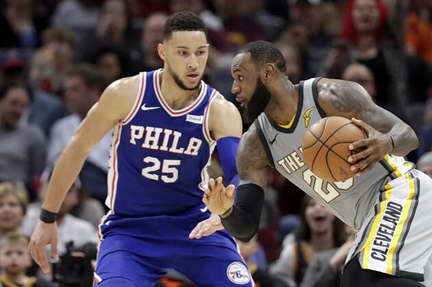 Cleveland Cavaliers' LeBron James (23) drives abasing Philadelphia 76ers' Ben Simmons (25), from Australia, in the second half of an NBA basketball game, Thursday, March 1, 2018, in Cleveland. (AP Photo/Tony Dejak)