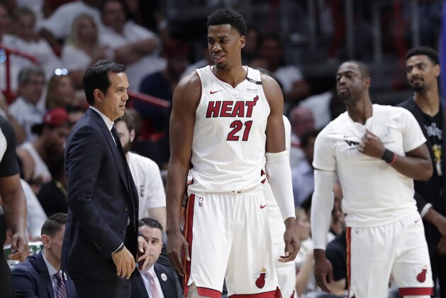 Miami Heat's Hassan Whiteside (21) stands on the sidelines with head coach Erik Spoelstra, left, during the second half of Game 3 of a first-round NBA basketball playoff series against the Philadelphia 76ers, Thursday, April 19, 2018, in Miami. The 76ers won 128-108. (AP Photo/Lynne Sladky)