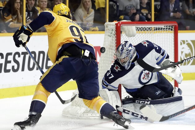 Winnipeg Jets goalie Connor Hellebuyck (37) blocks a shot by Nashville Predators center Ryan Johansen (92) during the second period in Game 5 of an NHL hockey second-round playoff series Saturday, May 5, 2018, in Nashville, Tenn. (AP Photo/Mark Humphrey)