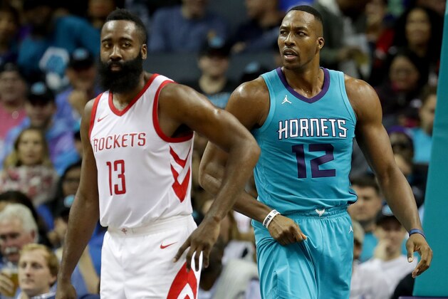 CHARLOTTE, NC - OCTOBER 27:  James Harden #13 of the Houston Rockets and Dwight Howard #12 of the Charlotte Hornets watch on during their game at Spectrum Center on October 27, 2017 in Charlotte, North Carolina.  NOTE TO USER: User expressly acknowledges and agrees that, by downloading and or using this photograph, User is consenting to the terms and conditions of the Getty Images License Agreement.  (Photo by Streeter Lecka/Getty Images)