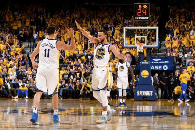 OAKLAND, CA - MAY 8:  Klay Thompson #11 and Stephen Curry #30 of the Golden State Warriors high five during the game against the New Orleans Pelicans in Game Five of the Western Conference Semifinals of the 2018 NBA Playoffs on May 8, 2018 at Oracle Arena in Oakland, California. NOTE TO USER: User expressly acknowledges and agrees that, by downloading and or using this photograph, user is consenting to the terms and conditions of Getty Images License Agreement. Mandatory Copyright Notice: Copyright 2018 NBAE (Photo by Garrett Ellwood/NBAE via Getty Images)