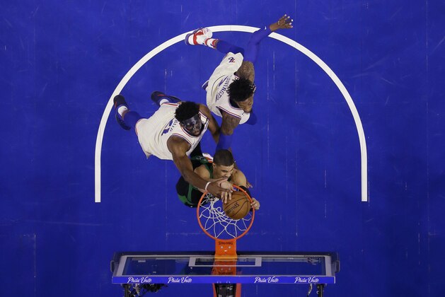 Boston Celtics' Jayson Tatum, center, dunks against Philadelphia 76ers' Joel Embiid, left, and Robert Covington during the first half of Game 3 of an NBA basketball second-round playoff series Saturday, May 5, 2018, in Philadelphia. (AP Photo/Matt Slocum)