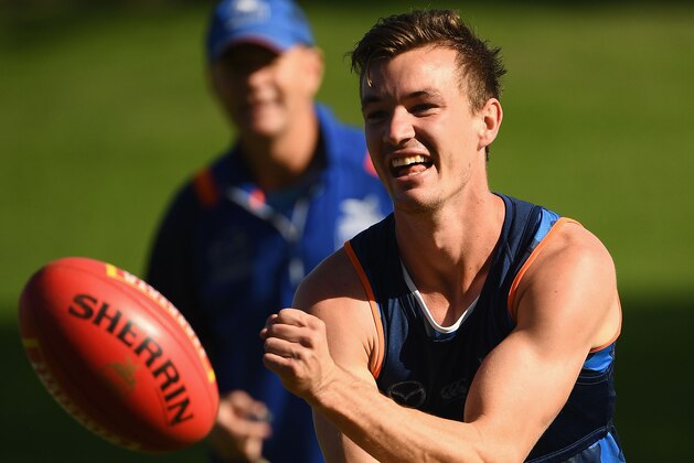 MELBOURNE, AUSTRALIA - MAY 08:  Kayne Turner of the Kangaroos  handballs during a North Melbourne Kangaroos AFL training session at Catani Gardens on May 8, 2018 in Melbourne, Australia.  (Photo by Quinn Rooney/Getty Images)
