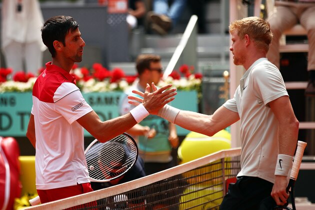 MADRID, SPAIN - MAY 09:  Kyle Edmund of Great Britain shakes hands with Novak Djokovic (l) of Serbia after winning their second round match during day five of the Mutua Madrid Open at La Caja Magica on May 9, 2018 in Madrid, Spain.  (Photo by Clive Brunskill/Getty Images)