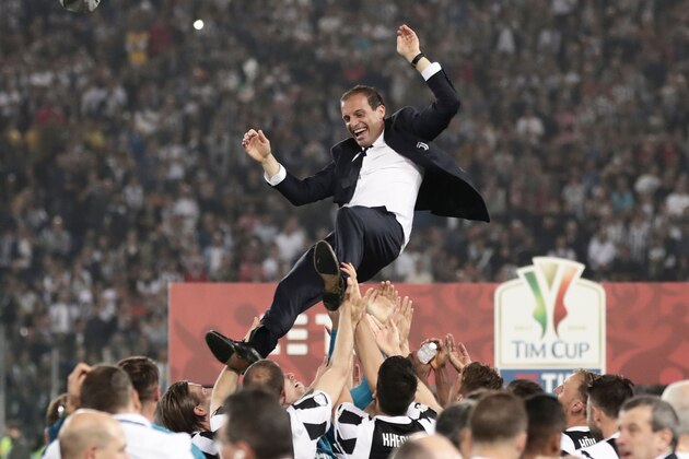 Juventus players lift Juventus' coach from Italy Massimiliano Allegri  after winning the Italian Tim Cup (Coppa Italia) final Juventus vs AC Milan at the Olympic stadium on May 9, 2018 in Rome. - Juventus crushed AC Milan 4-0 on today at the Stadio Olimpico to win a fourth consecutive Italian Cup. Mehdi Benatia opened the floodgates after 56 minutes for the first of a double of the night for the Moroccan with Douglas Costa also finding the net in the space of nine minutes. A Nikola Kalinic own goal accounted for the fourth (Photo by Isabella Bonotto / AFP)        (Photo credit should read ISABELLA BONOTTO/AFP/Getty Images)