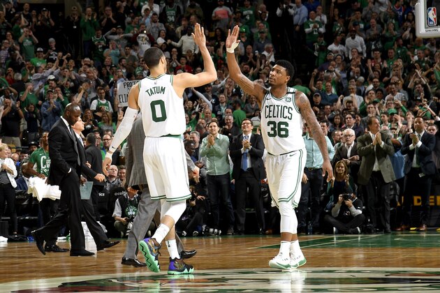 BOSTON, MA - MAY 9:  Jayson Tatum #0 and Marcus Smart #36 of the Boston Celtics high five during the game against the Philadelphia 76ers in Game Five of the Eastern Conference Semifinals of the 2018 NBA Playoffs on May 9, 2018 at TD Garden in Boston, Massachusetts. NOTE TO USER: User expressly acknowledges and agrees that, by downloading and or using this Photograph, user is consenting to the terms and conditions of the Getty Images License Agreement. Mandatory Copyright Notice: Copyright 2018 NBAE (Photo by Brian Babineau/NBAE via Getty Images)