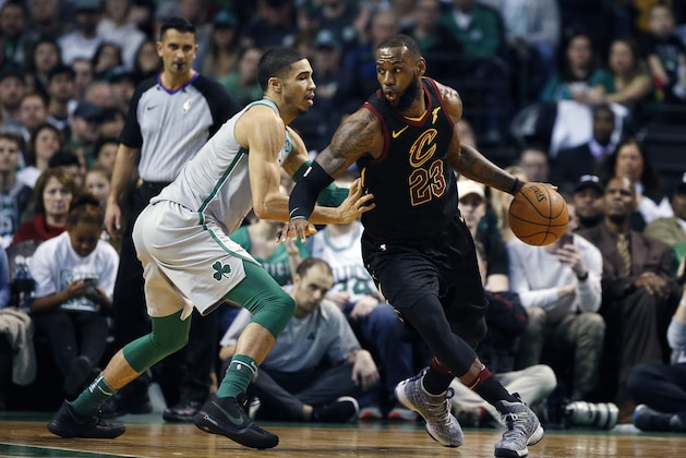 Cleveland Cavaliers' LeBron James (23) drives past Boston Celtics' Jayson Tatum during the second quarter of an NBA basketball game in Boston, Sunday, Feb. 11, 2018. (AP Photo/Michael Dwyer)