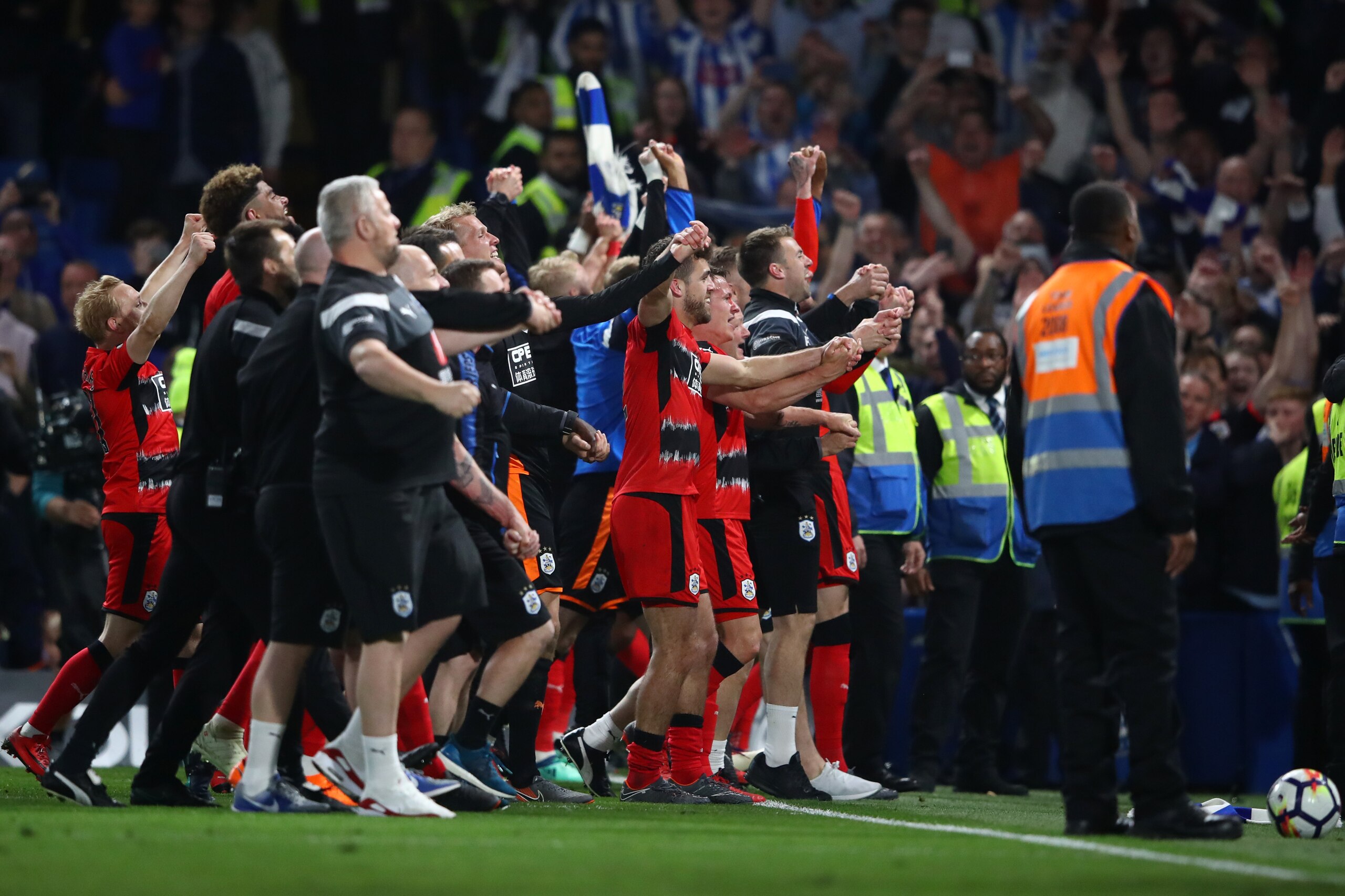 LONDON, ENGLAND - MAY 09: The Huddersfield Town team celebrate avoiding relegation after the Premier League match between Chelsea and Huddersfield Town at Stamford Bridge on May 9, 2018 in London, England.  (Photo by Clive Mason/Getty Images)