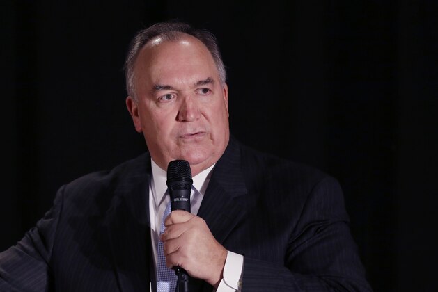 In a photo from Oct. 13, 2014, former Michigan Gov. John Engler is seen during a Republican rally in Troy, Mich. (AP Photo/Carlos Osorio)