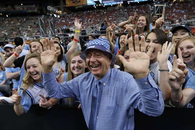 FILE - In this April 3, 2017, file photo, ESPN's Dick Vitale stands with North Carolina fans before the team's championship game against Gonzaga in the NCAA men's college basketball tournament in Glendale, Ariz. Vitale says he has turned his life “24-7” into raising money for pediatric cancer research. “I will do this is until my last breath,” he said Wednesday, May 3. “One of the reasons I'm upset is that just four cents of every dollar raised to fight cancer goes to pediatric cancer research and that shouldn't be happening.” (AP Photo/David J. Phillip, File)