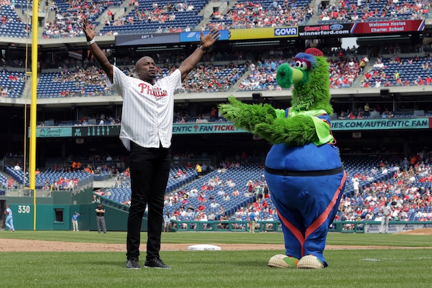 PHILADELPHIA, PA - MAY 10: American Ninja Warrior co-host and former NFL player, Akbar Gbajabiamila, performs on the field between innings with the Phillie Phanatic during a game between the San Francisco Giants and the Philadelphia Phillies at Citizens Bank Park on May 10, 2018 in Philadelphia, Pennsylvania. The Phillies won 6-3. (Photo by Hunter Martin/Getty Images)