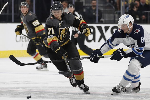Vegas Golden Knights center William Karlsson (71) battles for the puck with Winnipeg Jets defenseman Jacob Trouba (8) during the second period of an NHL hockey game Friday, Nov. 10, 2017, in Las Vegas. (AP Photo/John Locher)
