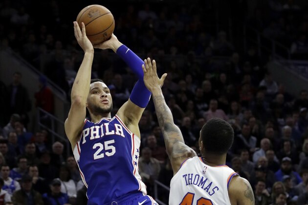 Philadelphia 76ers' Ben Simmons, left, goes up for a shot against New York Knicks' Lance Thomas during the second half of an NBA basketball game, Wednesday, March 28, 2018, in Philadelphia. Philadelphia won 118-101. (AP Photo/Matt Slocum)