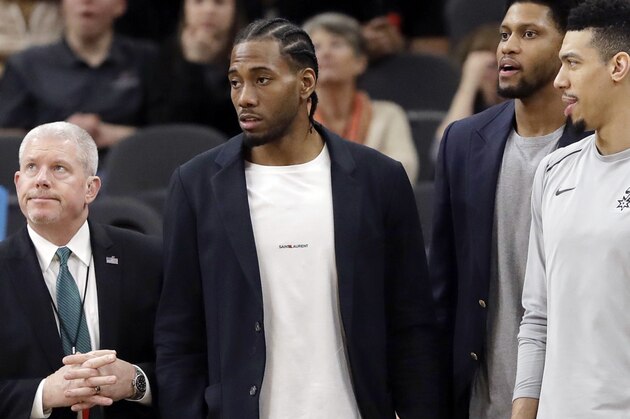 FILE - In this Jan. 21, 2018, file photo, San Antonio Spurs guard Danny Green, right, stands at the bench with injured teammates Kawhi Leonard, second from left, and Rudy Gay, center, during the second half of an NBA basketball game against the Indiana Pacers in San Antonio. Leonard plans on returning this season and wants to remain with the Spurs for life, refuting reports of dissension with the star forward and the only franchise he has played for. Leonard has missed all but nine games this season with right quadriceps tendinopathy, which initially flared up late in the offseason.  (AP Photo/Eric Gay, File)