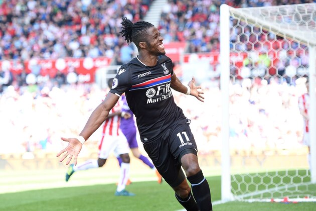 Crystal Palace's Ivorian striker Wilfried Zaha celebrates after scoring the equalising goal during the English Premier League football match between Stoke City and Crystal Palace at the Bet365 Stadium in Stoke-on-Trent, central England on May 5, 2018. (Photo by Oli SCARFF / AFP) / RESTRICTED TO EDITORIAL USE. No use with unauthorized audio, video, data, fixture lists, club/league logos or 'live' services. Online in-match use limited to 75 images, no video emulation. No use in betting, games or single club/league/player publications. /         (Photo credit should read OLI SCARFF/AFP/Getty Images)
