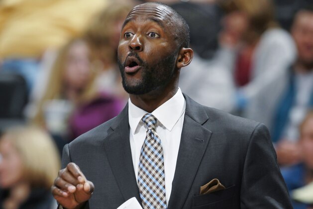 Philadelphia 76ers assistant coach Lloyd Pierce directs players against the Denver Nuggets in the third quarter of the Sixers' 114-102 victory in an NBA basketball game in Denver on Wednesday, Jan. 1, 2014. (AP Photo/David Zalubowski)