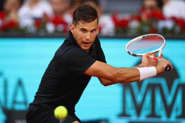 MADRID, SPAIN - MAY 11:  Dominic Thiem of Austria plays a backhand against Rafael Nadal of Spain in their quarter final match during day seven of the Mutua Madrid Open tennis tournament at the Caja Magica  on May 11, 2018 in Madrid, Spain.  (Photo by Clive Brunskill/Getty Images)