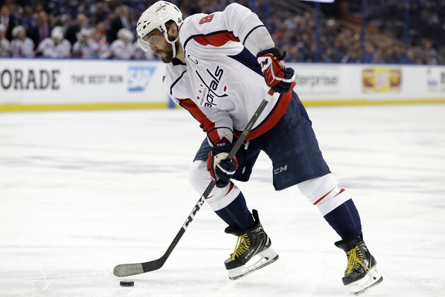 Washington Capitals left wing Alex Ovechkin (8) picks up his own rebound on a shot against the Tampa Bay Lightning during the third period of Game 1 of the NHL Eastern Conference finals hockey playoff series Friday, May 11, 2018, in Tampa, Fla. (AP Photo/Chris O'Meara)