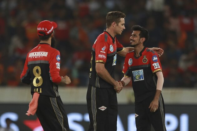 Royal Challengers Bangalore bowler Tim Southee, centre, celebrates the wicket of Shakib Al Hasan with Yuzvendra Chahal during VIVO IPL cricket T20 match against Sunrisers Hyderabad in Hyderabad, India, Monday, May 7, 2018. (AP Photo/Mahesh Kumar A.)