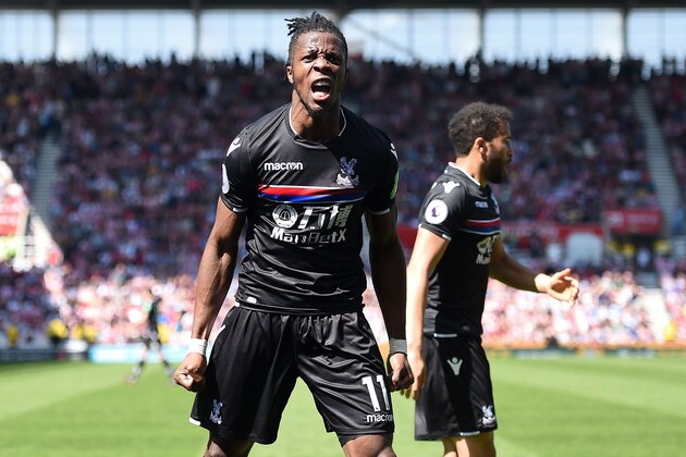 Crystal Palace's Ivorian striker Wilfried Zaha (L) celebrates after scoring the equalising goal during the English Premier League football match between Stoke City and Crystal Palace at the Bet365 Stadium in Stoke-on-Trent, central England on May 5, 2018. (Photo by Oli SCARFF / AFP) / RESTRICTED TO EDITORIAL USE. No use with unauthorized audio, video, data, fixture lists, club/league logos or 'live' services. Online in-match use limited to 75 images, no video emulation. No use in betting, games or single club/league/player publications. /         (Photo credit should read OLI SCARFF/AFP/Getty Images)