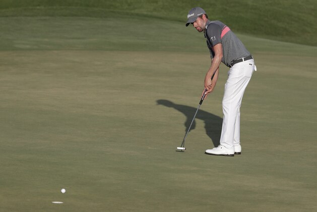 Webb Simpson watches his putt on the 18 green, during the third round of The Players Championship golf tournament Saturday, May 12, 2018, in Ponte Vedra Beach, Fla. Simpson leads the tournament with a score of 19-under-par. (AP Photo/Lynne Sladky)
