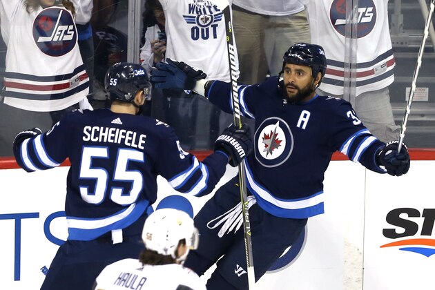 WINNIPEG, MB - MAY 12:  Dustin Byfuglien #33 of the Winnipeg Jets is congratulated by his teammate Mark Scheifele #55 after scoring a first period goal against the Vegas Golden Knights in Game One of the Western Conference Finals during the 2018 NHL Stanley Cup Playoffs at Bell MTS Place on May 12, 2018 in Winnipeg, Canada.  (Photo by Jason Halstead/Getty Images)