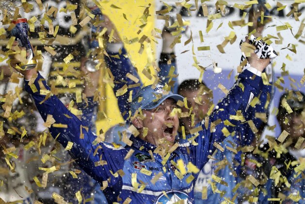 Kevin Harvick is covered in confetti as he celebrates winning the NASCAR Cup Series auto race at Kansas Speedway in Kansas City, Kan., Saturday, May 12, 2018. (AP Photo/Colin E. Braley)