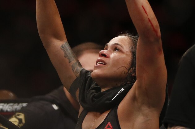 Wearing the champion's belt, Amanda Nunes, from Brazil, celebrates after defeating Raquel Pennington, from the United States, during their UFC women's bantamweight mixed martial arts bout in Rio de Janeiro, Brazil, early Sunday, May 13, 2018. (AP Photo/Leo Correa)
