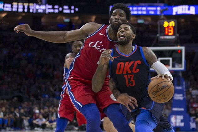 PHILADELPHIA, PA - DECEMBER 15: Paul George #13 of the Oklahoma City Thunder drives to the basket against Joel Embiid #21 of the Philadelphia 76ers in double overtime at the Wells Fargo Center on December 15, 2017 in Philadelphia, Pennsylvania. The Thunder defeated the 76ers 119-117 in triple overtime. NOTE TO USER: User expressly acknowledges and agrees that, by downloading and or using this photograph, User is consenting to the terms and conditions of the Getty Images License Agreement. (Photo by Mitchell Leff/Getty Images)