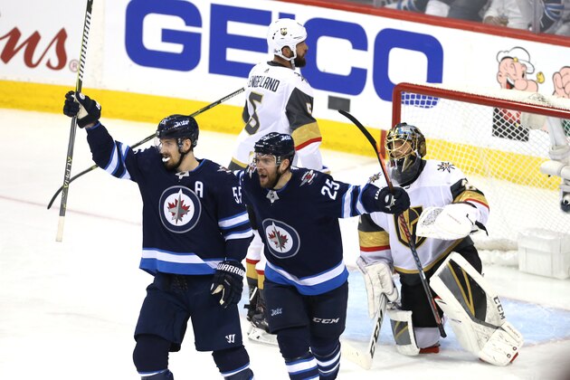 WINNIPEG, MB - MAY 12: Marc-Andre Fleury #29 of the Vegas Golden Knights reacts as Mark Scheifele #55 is congratulated by his teammate Paul Stastny #25 of the Winnipeg Jets after scoring a second period goal in Game One of the Western Conference Finals during the 2018 NHL Stanley Cup Playoffs at Bell MTS Place on May 12, 2018 in Winnipeg, Canada.  (Photo by Jason Halstead/Getty Images)