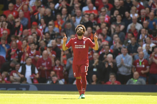 Liverpool's Egyptian midfielder Mohamed Salah celebrates after scoring during the English Premier League football match between Liverpool and Brighton and Hove Albion at Anfield in Liverpool, north west England on May 13, 2018. (Photo by Paul ELLIS / AFP) / RESTRICTED TO EDITORIAL USE. No use with unauthorized audio, video, data, fixture lists, club/league logos or 'live' services. Online in-match use limited to 75 images, no video emulation. No use in betting, games or single club/league/player publications. /         (Photo credit should read PAUL ELLIS/AFP/Getty Images)