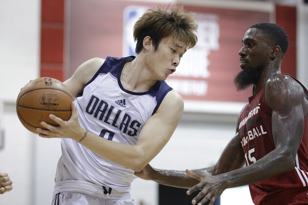 Dallas Mavericks' Ding Yanyuhang, left, of China, drives around Miami Heat's Okaro White during the first half of an NBA summer league basketball game, Tuesday, July 11, 2017, in Las Vegas. (AP Photo/John Locher)