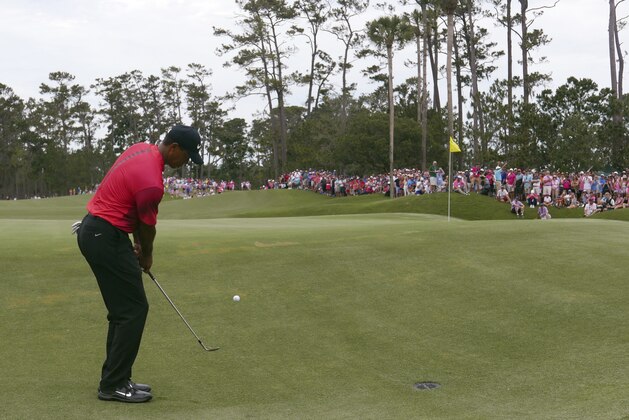 Tiger Woods chips onto the second green, during the final round of the The Players Championship golf tournament Sunday, May 13, 2018, in Ponte Vedra Beach, Fla. (AP Photo/John Raoux)