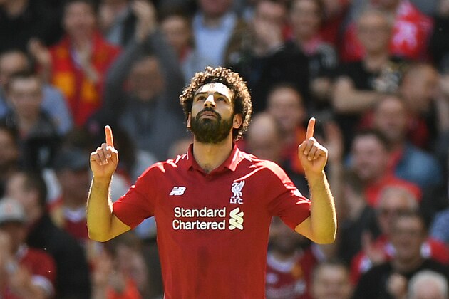 Liverpool's Egyptian midfielder Mohamed Salah celebrates after scoring during the English Premier League football match between Liverpool and Brighton and Hove Albion at Anfield in Liverpool, north west England on May 13, 2018. (Photo by Paul ELLIS / AFP) / RESTRICTED TO EDITORIAL USE. No use with unauthorized audio, video, data, fixture lists, club/league logos or 'live' services. Online in-match use limited to 75 images, no video emulation. No use in betting, games or single club/league/player publications. /         (Photo credit should read PAUL ELLIS/AFP/Getty Images)