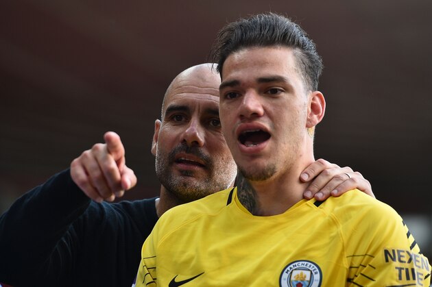 Manchester City's Spanish manager Pep Guardiola (L) talks with Manchester City's Brazilian goalkeeper Ederson (R) at the end of the English Premier League football match between Southampton and Manchester City at St Mary's Stadium in Southampton, southern England on May 13, 2018. (Photo by Glyn KIRK / AFP) / RESTRICTED TO EDITORIAL USE. No use with unauthorized audio, video, data, fixture lists, club/league logos or 'live' services. Online in-match use limited to 75 images, no video emulation. No use in betting, games or single club/league/player publications. /         (Photo credit should read GLYN KIRK/AFP/Getty Images)