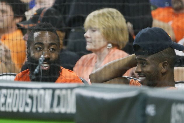 Houston Rockets James Harden and Chris Paul have some fun during the fourth inning of Game 2 of baseball's American League Championship Series between the Houston Astros and the New York Yankees Saturday, Oct. 14, 2017, in Houston. (AP Photo/Tony Gutierrez)
