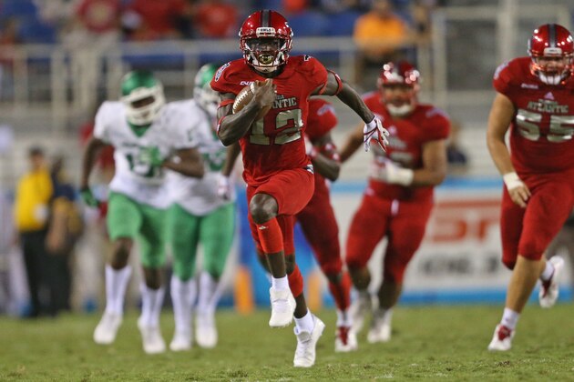 BOCA RATON, FL - OCTOBER 21: John Franklin III #12 of the Florida Atlantic Owls runs for a touchdown against the North Texas Mean Green during fourth quarter action on October 21, 2017 at FAU Stadium in Boca Raton, Florida. FAU defeated North Texas 69-31. (Photo by Joel Auerbach/Getty Images)