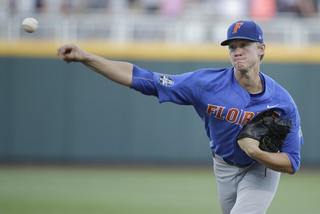 Florida pitcher Brady Singer works against Louisville during the seventh inning of an NCAA College World Series baseball game in Omaha, Neb., Tuesday, June 20, 2017. Florida won 5-1. (AP Photo/Nati Harnik)
