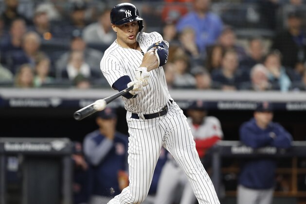 New York Yankees designated hitter Giancarlo Stanton hits a third-inning, two-run double off Boston Red Sox starting pitcher Rick Porcello in a baseball game in New York, Wednesday, May 9, 2018. (AP Photo/Kathy Willens)