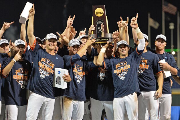 Omaha, NE - JUNE 24:  Players and coaches of the Virginia Cavaliers hold up the National Championship trophy after defeating the Vanderbilt Commodores during game three of the College World Series Championship Series on June 24, 2015 at TD Ameritrade Park in Omaha, Nebraska.  (Photo by Peter Aiken/Getty Images)