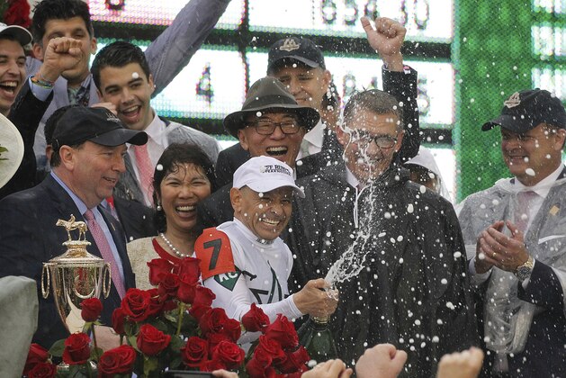 Mike Smith celebrates after riding Justify to victory during the 144th running of the Kentucky Derby horse race at Churchill Downs Saturday, May 5, 2018, in Louisville, Ky. (AP Photo/Garry Jones)
